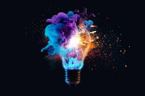 istock Creative light bulb explodes with colorful dry paint, sparks and splashes on a black background, concept. Think differently creative idea concept. Motion Color drop in water, Ink swirling 2181040256