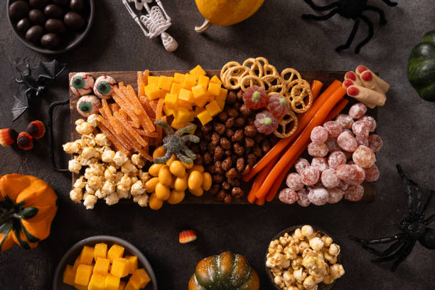 istock Halloween charcuterie board with pumpkin, chocolate candy, spider, crackers. 2181040449