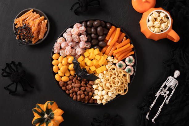 istock Halloween charcuterie board with pumpkin, chocolate candy, spider, crackers. 2181044592