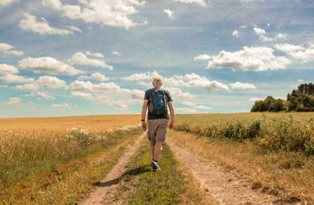 Active senior man walking through a countryside.