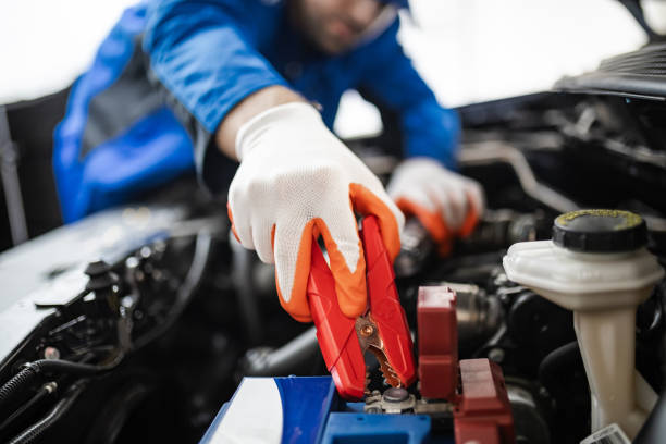 istock A mechanic using jumper cables to start a car battery in a workshop during daytime 2181048253