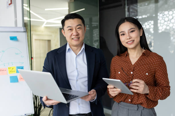 istock Confident business professionals collaborating in modern office environment with technology 2181048472