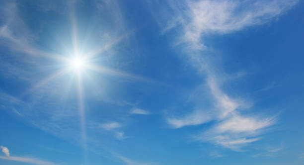 istock Sun on beautiful blue sky with fluffy clouds. 2181050642