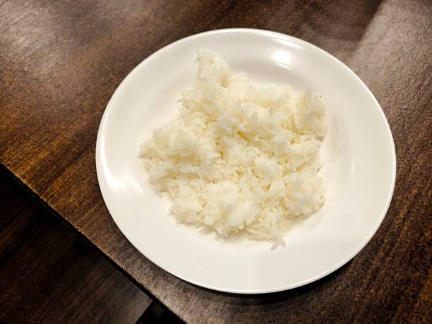 istock Cooked rice in ceramic bowl on wood table. Food menu concept 2181056866