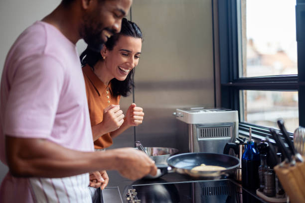 istock Young Couple Enjoys Cooking Together in Modern Kitchen 2181058158