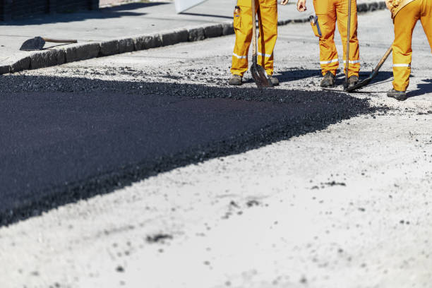istock Construction workers laying asphalt on a roadway in urban area during bright daylight hours 2181059482