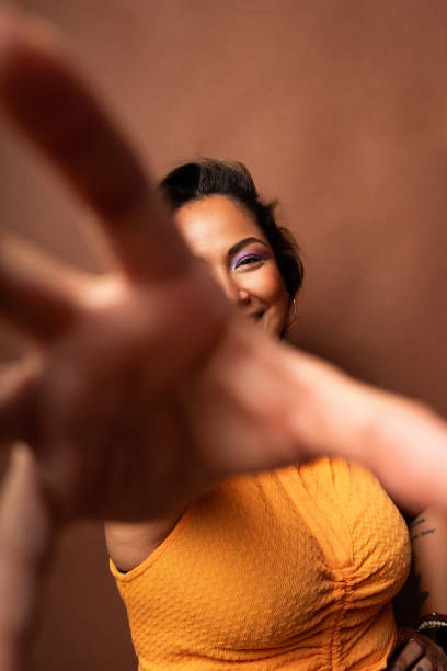 istock Young woman reaching towards camera with open hand 2181063305