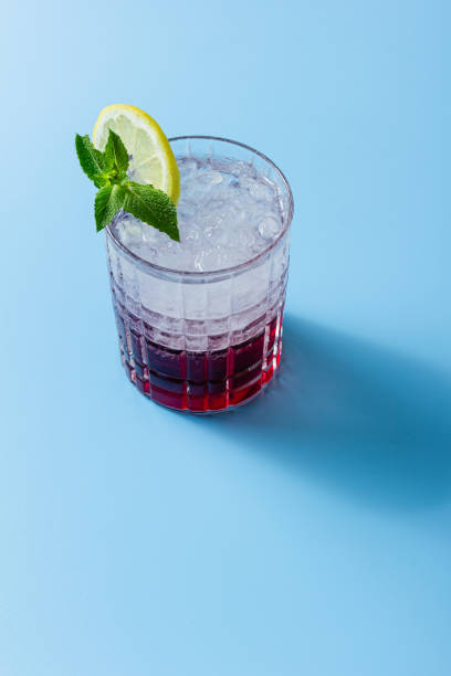 istock Cocktail with ice in a glass on a blue background 2181064129