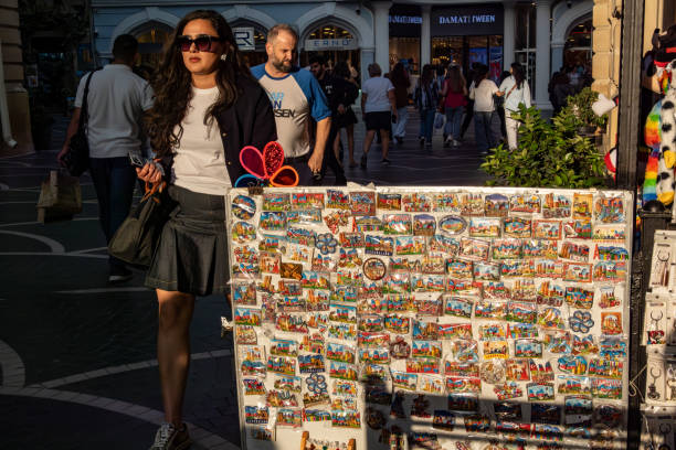 Baku, Azerbaijan Sept 22, 2024 Pedestrians pass a vendor selling pins and magnets with Azerbaijan motifs.