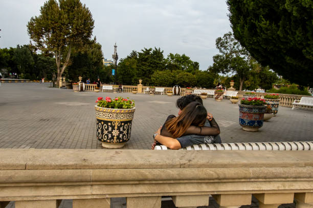 Bucharest, Romania - 06.04.2021:Vintage picture with two seniors sitting on a bench in a park and looking at the lake