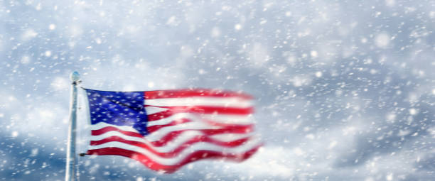 istock American Flag at flagpole during snow storm 2181068176