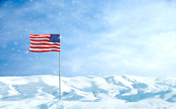 istock American Flag at flagpole during snow storm 2181068179