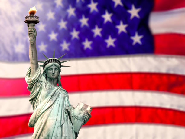 istock Conceptual Statue of Liberty over large American flag 2181068711