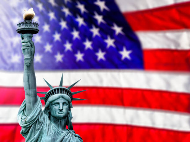 istock Conceptual Statue of Liberty over large American flag 2181068714