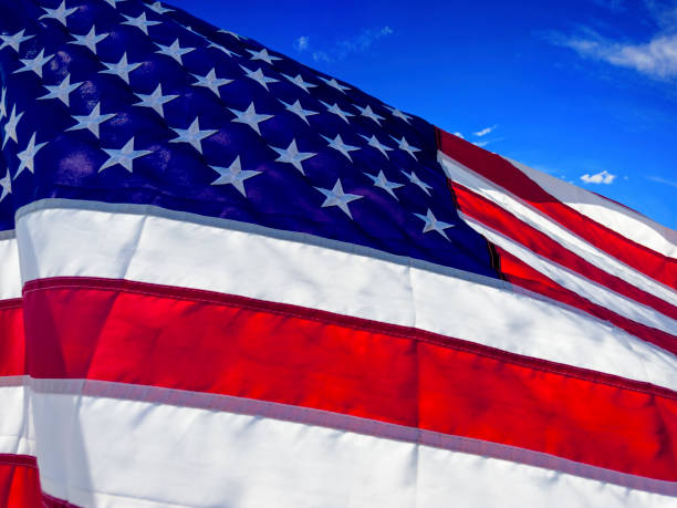 istock Close up American flag over blue sky 2181068727