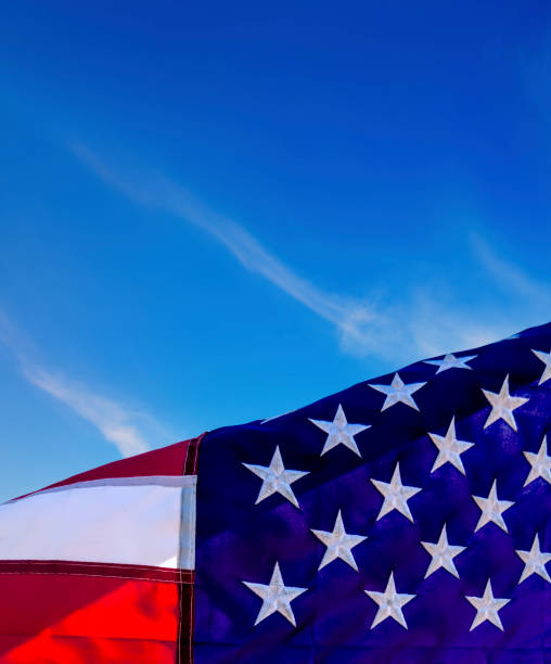 istock Close up American flag over blue sky 2181068742