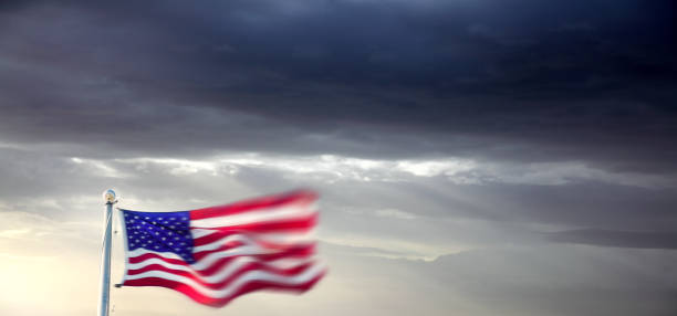 istock American flag at flagpole during tropical storm 2181068743