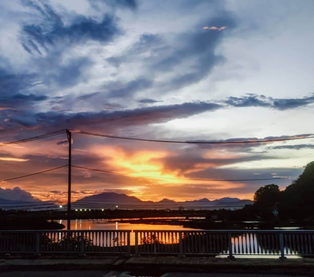 Beautiful sunset on the river with a bridge in the background. High quality photo