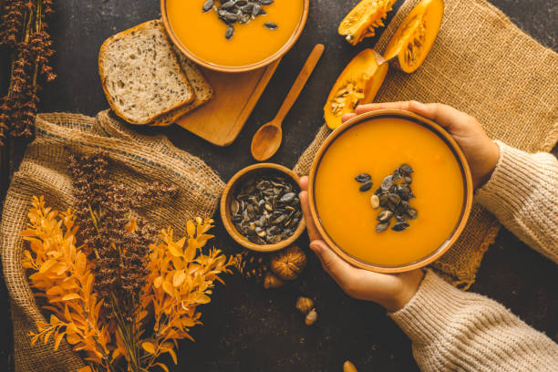 istock Pumpkin soup in hands, autumn cozy mood 2181080037
