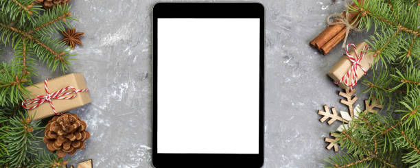 istock Digital tablet mock up with rustic Christmas gray cement background decorations for app presentation. top view with copy space 2181080665