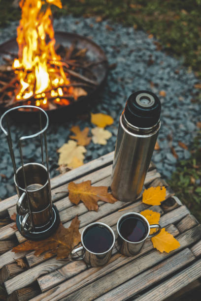 istock Themed trip. The man pours a hot drink into the thermos 2181080787