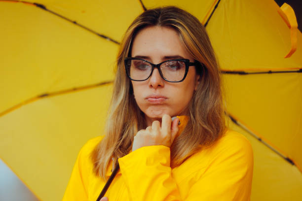 istock Sad Woman with Rain on Her Glasses During Rainstorm 2181081589