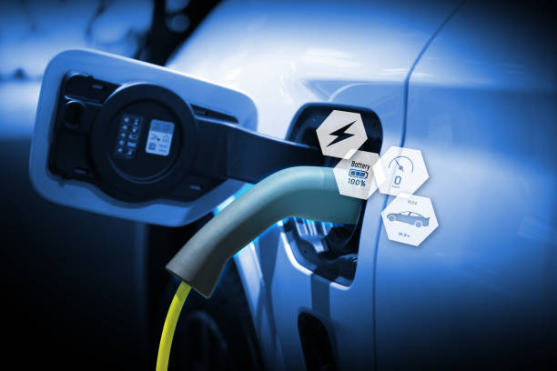 istock Power cable pump plug in charging power to electric vehicle EV car. 2181089277