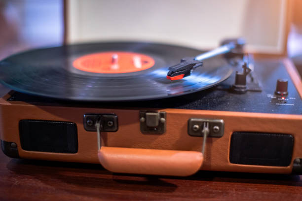 istock Selective focus to vintage record player on a table in a music studio playing an old vinyl album. Close-up image of a vintage record player. 2181094436