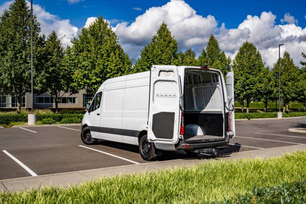 istock Commercial compact white mini van make delivery to the customer standing with open back doors on the parking lot for a cargo unload 2181106576