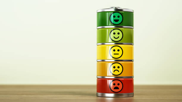 A stack of colorful battery indicators showcases different facial expressions, ranging from happy to sad, emphasizing emotional states in a minimalistic setting.