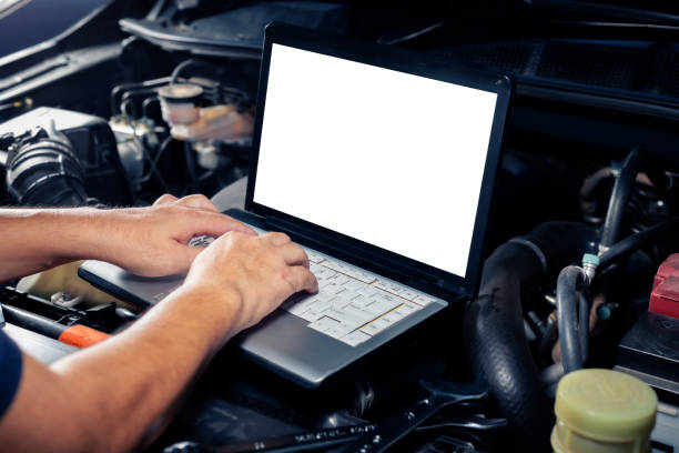 istock Car inspection service using a modern computer system.  and a modern mechanic in the garage Auto mechanics use computer software to check two engines are running and repair them. 2181115004