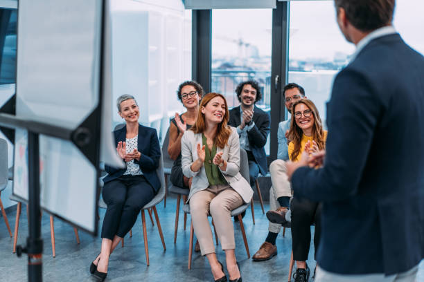 istock Businesspeople applauding during a seminar in conference hall. 2181115656