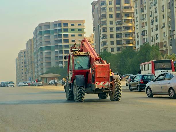 Cairo, Egypt, October 14 2024: wheeled excavator on its way to a construction site, a versatile machine for general excavating as well as road and bridge construction, a construction vehicle on road