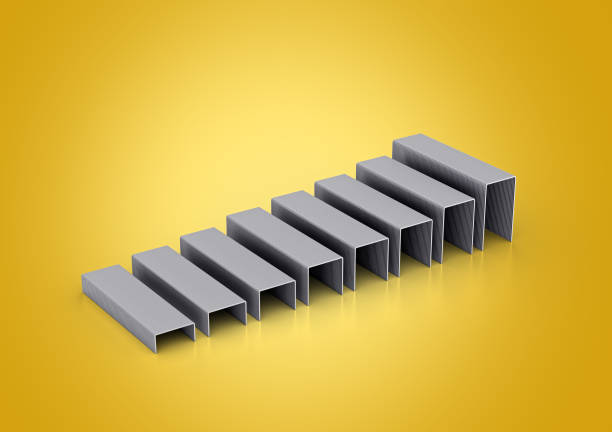 istock A Series Of Silver Metal Staple Pins Arranged In Parallel Rows On Yellow Background 3D Illustration 2181116152