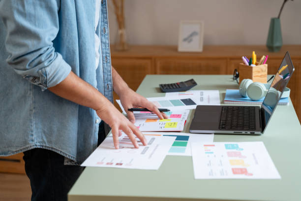 istock Marketing professional reviewing analytics and data in a bright office 2181117653
