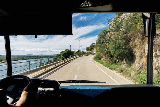 istock Bus journey with beautiful views through the front windshield. Mountains landscape. Riding along coastline background. 2181119825