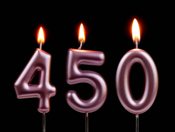 istock Pink birthday candles isolated on black background, number 450 2181122749