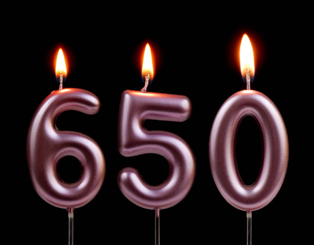 istock Pink birthday candles isolated on black background, number 650 2181122755