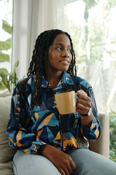 istock Smiling Woman Relaxing While Holding Coffee Mug 2181122819