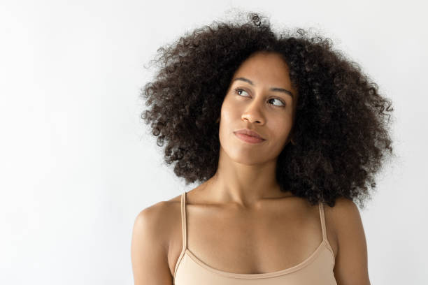 istock Young woman with afro hair thinking 2181125569