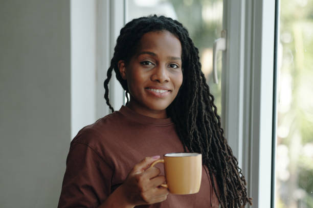 istock Young Woman Enjoying Morning Coffee by Window 2181127887