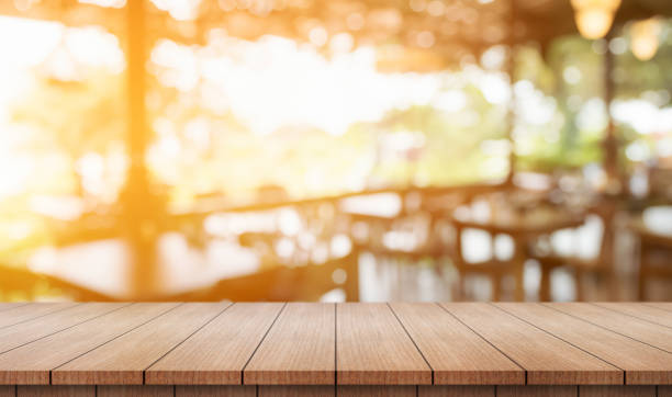 istock Empty wooden table top with lights bokeh on blur restaurant background. 2181128238
