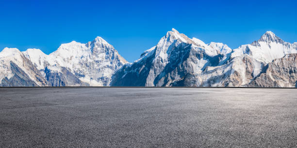 istock Asphalt road square and snow mountain natural landscape under blue sky 2181131489