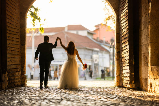 istock Newlyweds walking in old town 2181132110