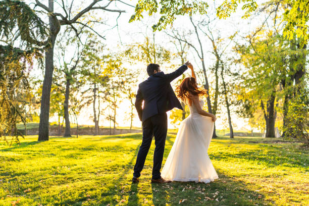 istock Newlyweds dancing in sunny park 2181132569