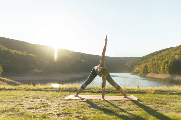 istock Woman practicing yoga, stretching in nature. Outdoor weekend 2181133129