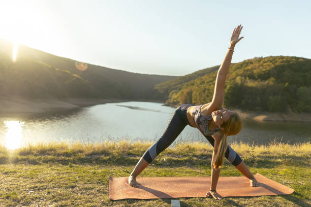 istock Woman practicing yoga, stretching in nature. Outdoor weekend 2181133132