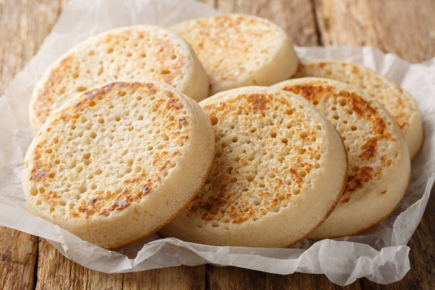 istock Tradition hot buttered crumpets closeup on parchment. Horizontal 2181133634