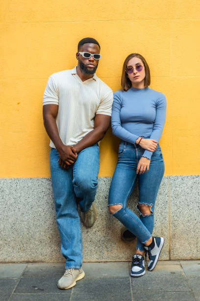 istock Cool modern multi-ethnic couple leaning on urban wall 2181133966