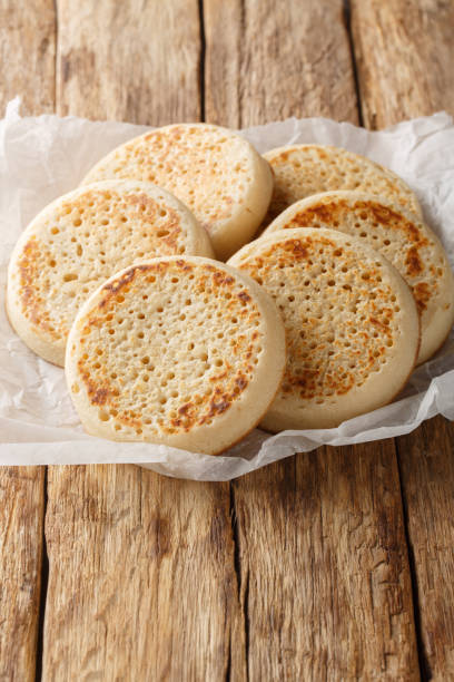 istock Freshly made English Crumpets close-up on parchment paper. Vertical 2181134004